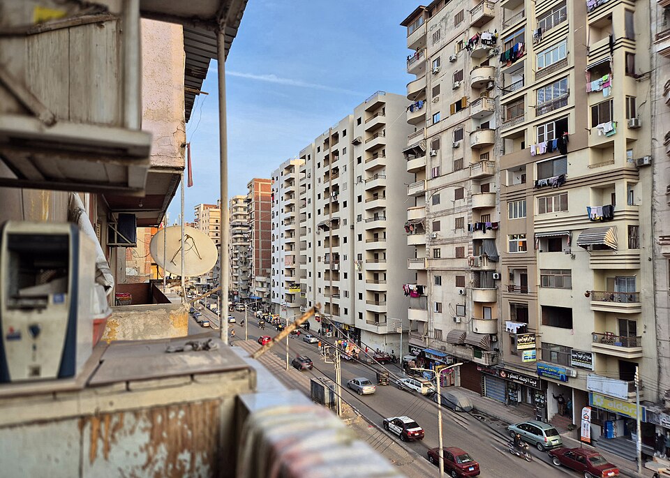 Dense mid-rise housing and traffic along a street in Mansoura, Dakahlia governorate, Egypt