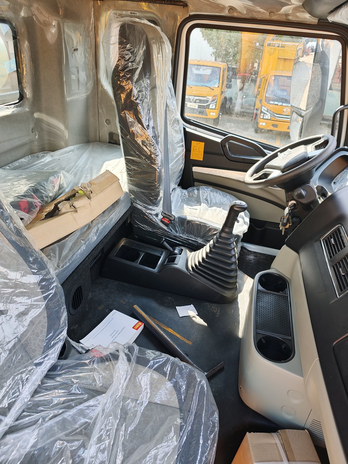 HOWO 25t Sewer Jetting & Vacuum Truck — Cab interior (protective film not yet removed)