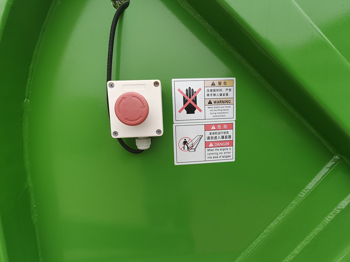 SITRAK 25t Refuse Compactor Truck — Rear emergency stop button and safety decals